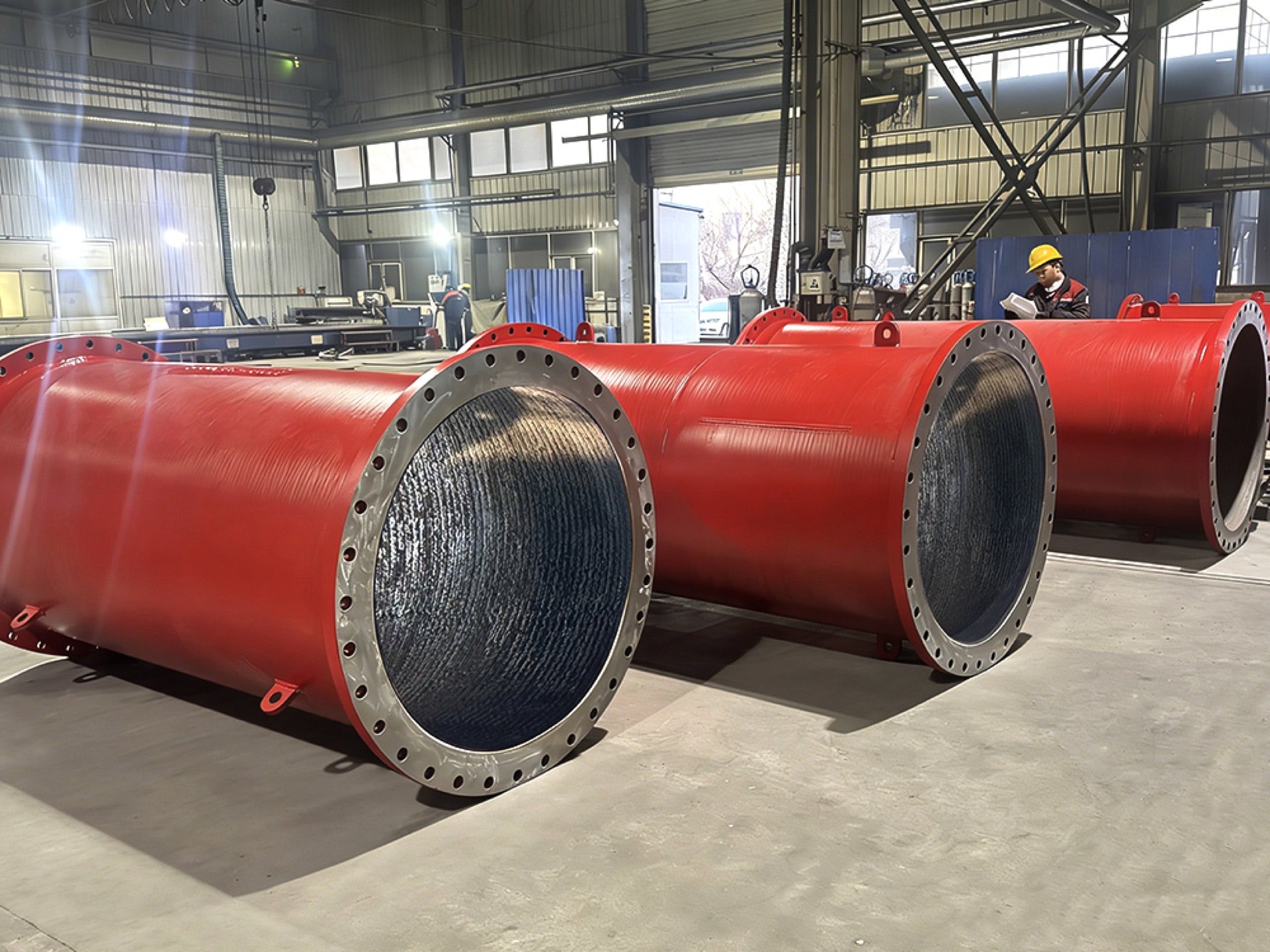 Red flanged wear pipes in the workshop