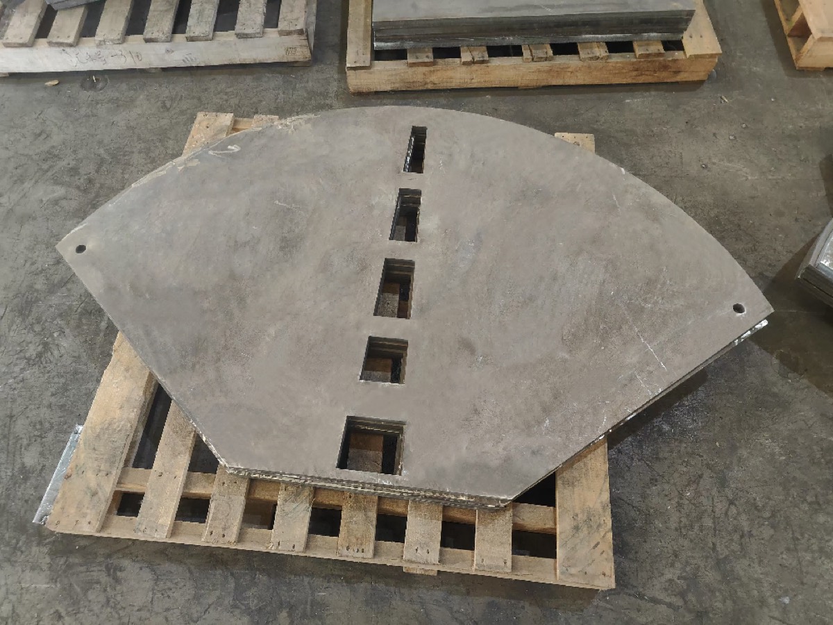Sector-shaped custom wear liner with a row of bolt holes